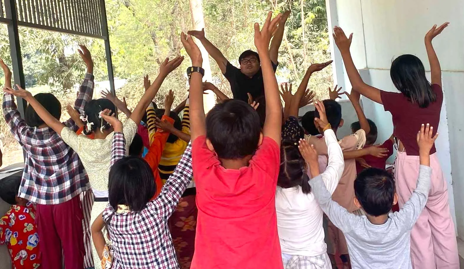 Children raising their hands during a group activity